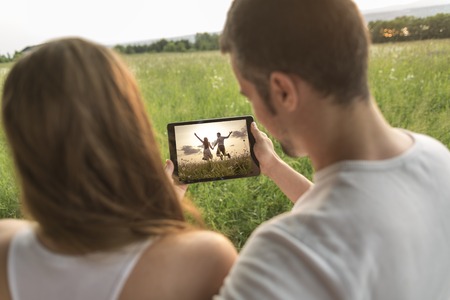 A Young couple in love outdoor at the sunset with a tabletの写真素材