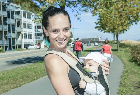 A Young mother jogging with a baby buggyの写真素材