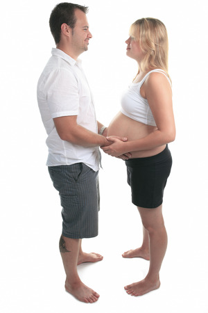 caucasian couple expecting baby smiling cheerful isolated studio on white backgroundの写真素材