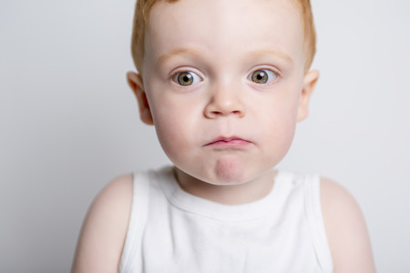 A redhead baby boy portrait over a isolated white backgroundの写真素材