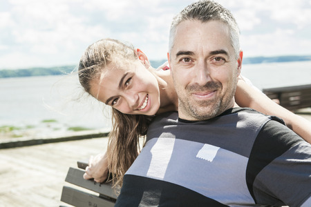 A Father with his daughter at sea getting good timeの写真素材