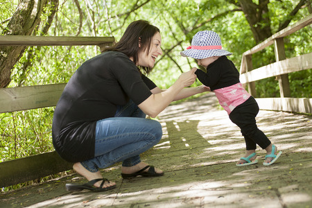 A Mother and daughter haviing good time in forest