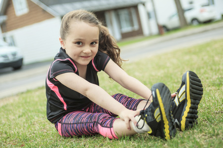 A girl stretching outside in spring season.の写真素材