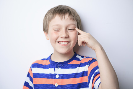 A Smiling little boy thinking about, isolated on white