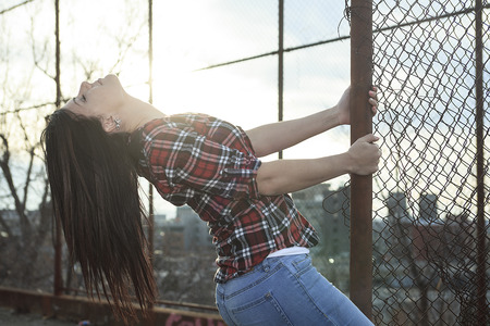 A woman holding a fesce in the sunset day timeの写真素材