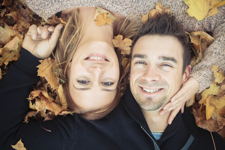 A Young happy couple in autumn seasonの写真素材