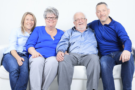 A family, happiness, generation and people sit on sofaの写真素材
