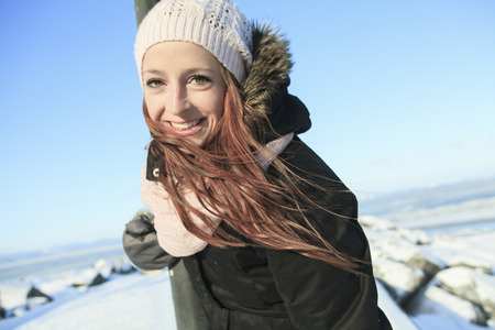 A woman portrait outside in winter seasonの写真素材