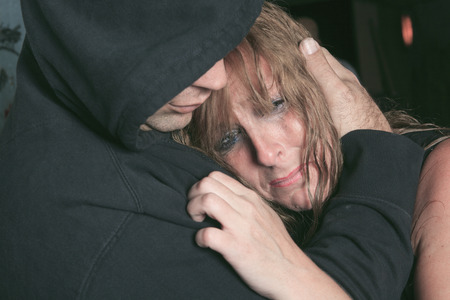 A men consoling woman and trying to calm down.の写真素材