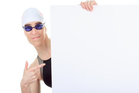 A woman swimmer in studio white background shoing a white card.の写真素材