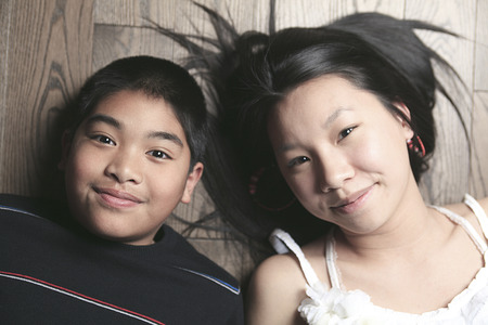 A happy kids on the floor laying on wooden floor
