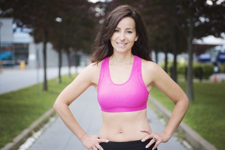 A woman running outdoors training for marathon run.の写真素材