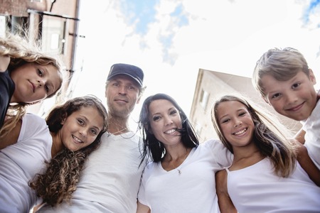 A Summer family portrait of parents and kids outside in urban styleの写真素材