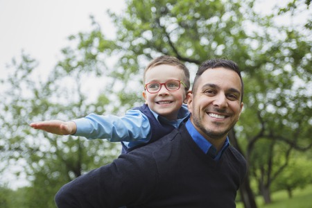 A Father and son in forest on a meadow