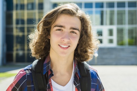 A Young handsome male student at the college, outdoors.の写真素材