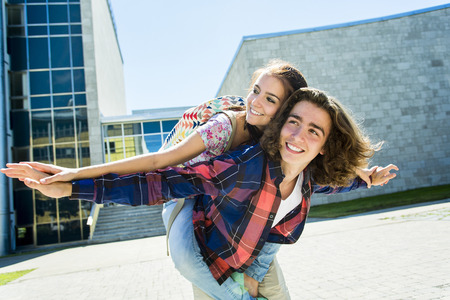Two Young handsome friends student at the college, outdoors.の写真素材