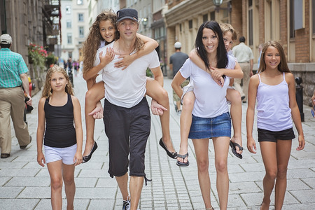 A Summer family portrait of parents and kids outside in urban styleの写真素材