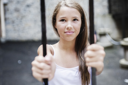 A Little sad child is lonesome with fenceの写真素材