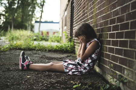 A eight years old school girl close to the schoolyardsの写真素材