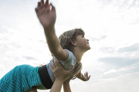 Beautiful portrait of a little girl outside on grassの写真素材
