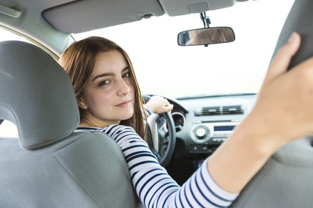 A Woman driver who is happy to have is new carの写真素材