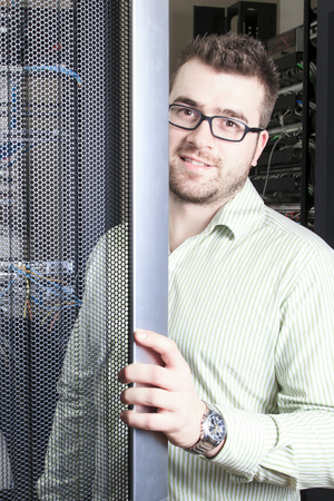 A network engineer working in server room.