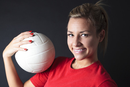 young, beauty volleyball player. Isolated on black in studioの写真素材