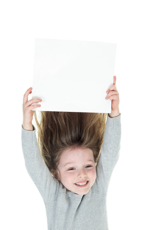 Young girl upside down isolated in whiteの写真素材