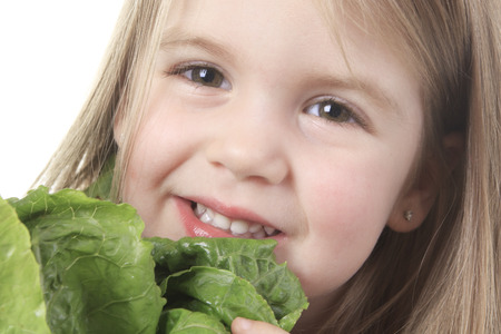 A child with a saled in front of a white background.の写真素材
