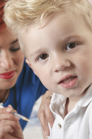 A Small boy with as nurse gives him a shot.の写真素材