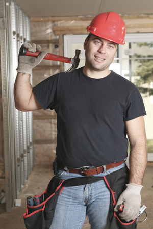 A construction men working on a bilding house.