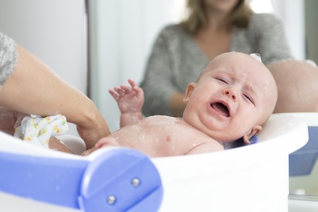 A cute Boy in bath tub in bathroomの写真素材