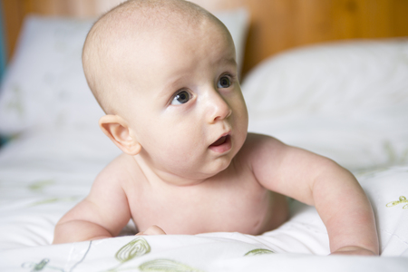 A four months baby portrait on a bed