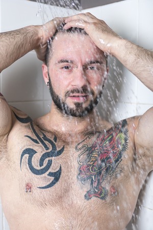 A sexy man with tattoo  on the showerの写真素材