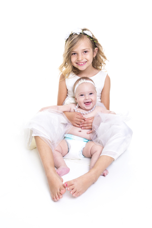 A portrait of two sisters in white dressesの写真素材