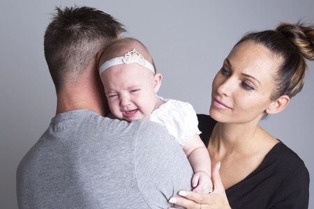 A baby cry on the hand of familyの写真素材