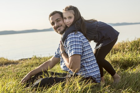 A Father with is daughter at the sunsetの写真素材