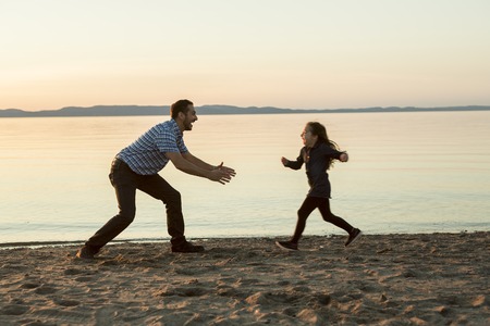 A Father with is daughter at the sunsetの写真素材