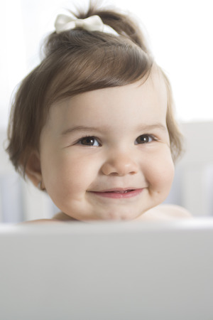 An Infant baby resting and playing in his little baby bedの写真素材