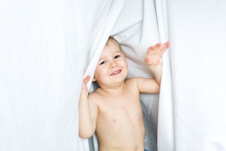 A Healthy Lifestyle of young little children boy on bedの写真素材