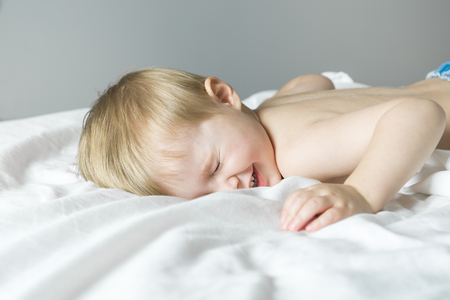 A Healthy Lifestyle of young little children boy on bedの写真素材