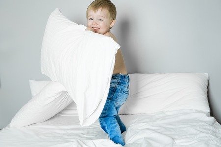 A Healthy Lifestyle of young little children boy on bedの写真素材