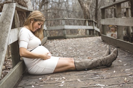 Portrait of a beautiful pregnant girl in the park in october monthの写真素材