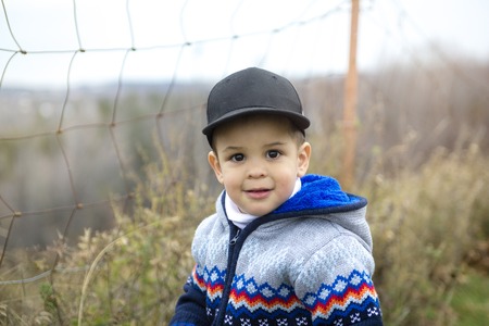 An Adorable cute little boy in autumn parkの写真素材