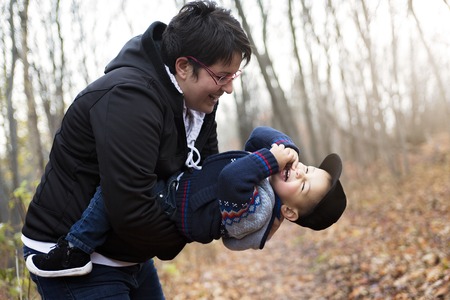 A family planting tree with spade outdoor in autumnの写真素材