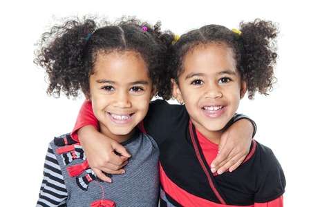 Twin adorable african little girl with beautiful hairstyle isolated over whiteの写真素材