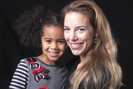 A family posing on a black background studioの写真素材
