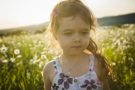 A Portrait of five years old caucasian child girl sunsetの写真素材