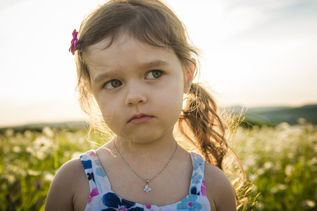 A Portrait of five years old caucasian child girl sunsetの写真素材