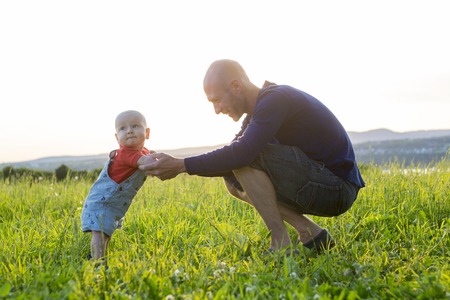 A father and baby at sunset on sunsetの写真素材